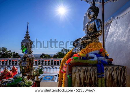 buddha stastue in temple on mountain sun background at udonthani