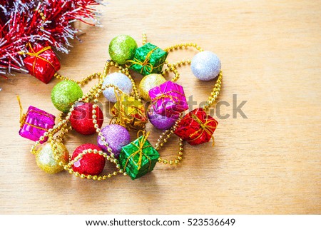 Christmas Background Concept : Christmas Decoration such as a present little boxes,ball,Tinsel, on the Wooden background 