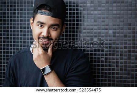 Young black man wearing smart watch on hand. Portrait of handsome black guy