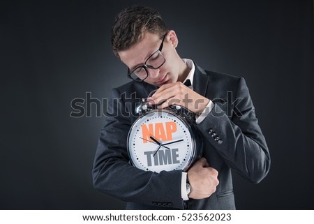 Businessman with clock sleeping in business concept