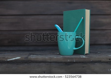 blue cup  and  books 