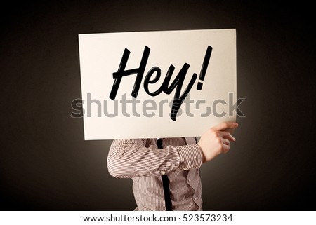 Young businessman hiding behind a greeting drawn on paper