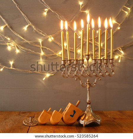 Low key Image of jewish holiday Hanukkah with menorah (traditional Candelabra)