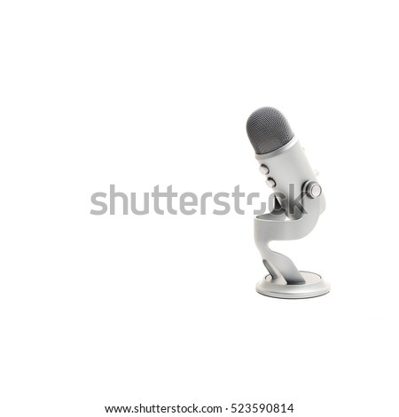 Close up of microphone isolated on white background. Modern space grey USB microphone with recording control buttons for podcast, broadcasting or voice over works. Clipping path and copy space