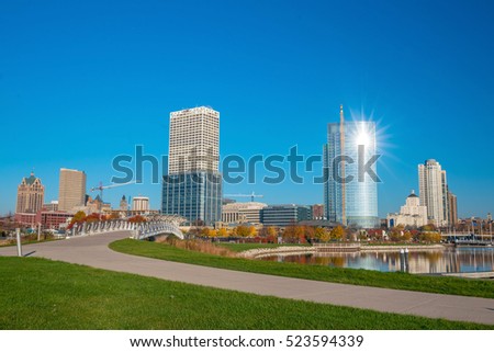 Milwaukee skyline  with city reflection in lake Michigan and harbor pier.