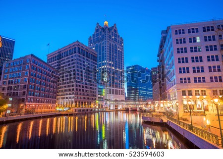 Downtown skyline with Buildings along the Milwaukee River at night, in Milwaukee, Wisconsin.