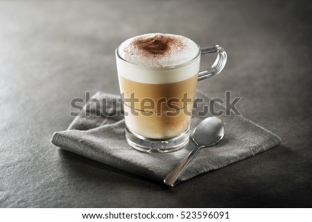 Cup of hot Cappuccino Coffee close up. Royalty-Free Stock Photo #523596091
