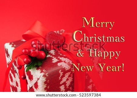 Gift box with red ribbon isolated on red color background. Merry Christmas and Happy New Year