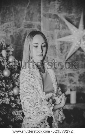 young woman sits amid the Christmas interior