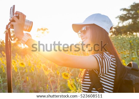 Portrait of a young attractive woman making selfie photo of Sunflower.Fair Lens Sun
