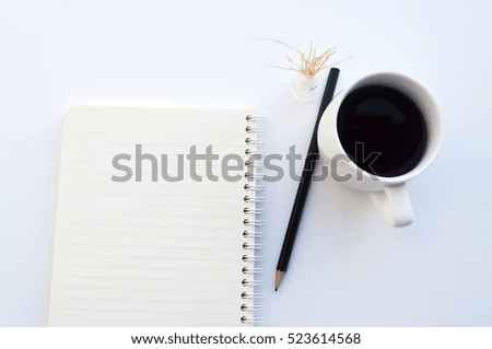 isolated empty notebook pencil and white cup coffee on white background. soft focus
