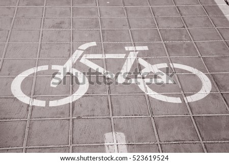 Cycle Path Symbol on Road Surface in Black and White Sepia Tone
