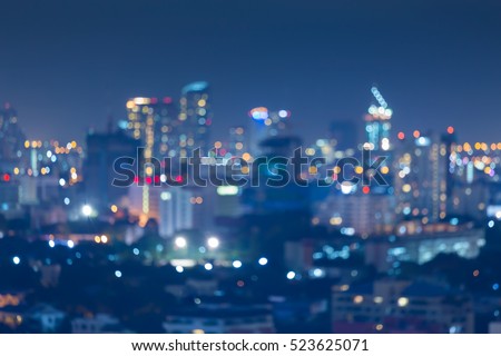 Night blurred bokeh light city office building, abstract background 