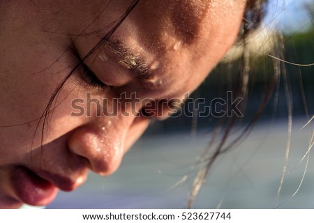 Closeup of sweating water drop on face asian woman. Sport female exercise in fitness. Royalty-Free Stock Photo #523627744