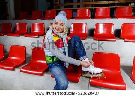 Beautiful girl in winter clothes with skates