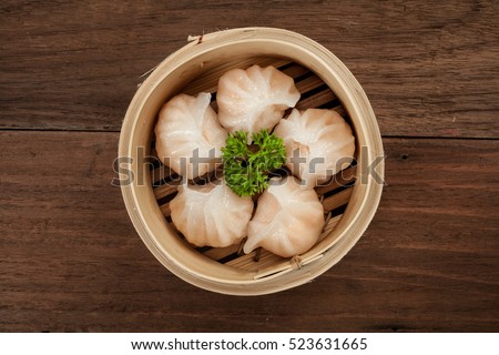 Chinese dumpling in a bamboo steamer box Royalty-Free Stock Photo #523631665