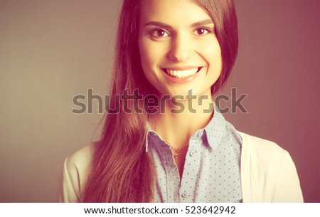 Portrait of a businesswoman , against dark background