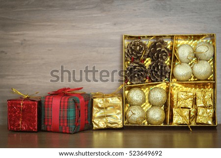 decorations and gift boxes on wooden board with Christmas background 