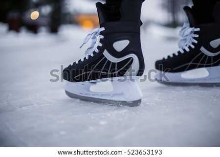 Legs of ice skater with start sign on the ice rink, view from above