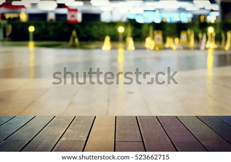 image of wooden table in front of abstract blurred background 