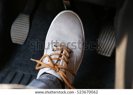 Human foot pressing car pedal Royalty-Free Stock Photo #523670062