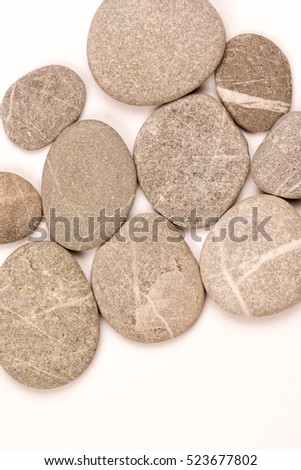Balanced grey stones over white background with copy spaceBalanced grey stones over white background with copy space