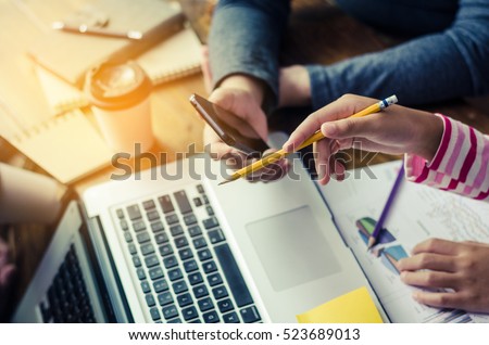 Team  businessmans job . working with laptop in open space office. Meeting report in progress. sun glare effect
 Royalty-Free Stock Photo #523689013