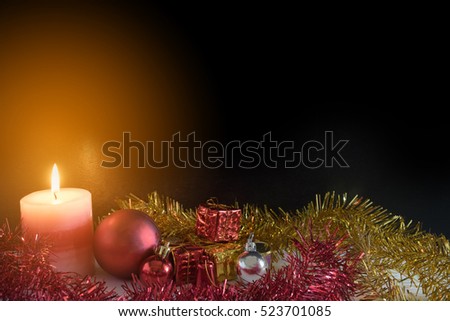 Candle light, christmas ball and small presents with copy space for Christmas concept
