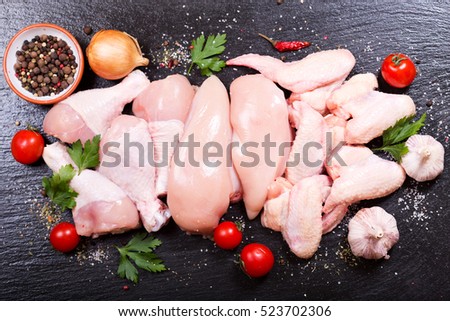 fresh chicken meat on dark board, top view. Royalty-Free Stock Photo #523702306