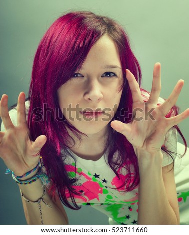 Emo look   girl with red hair on  gray background
