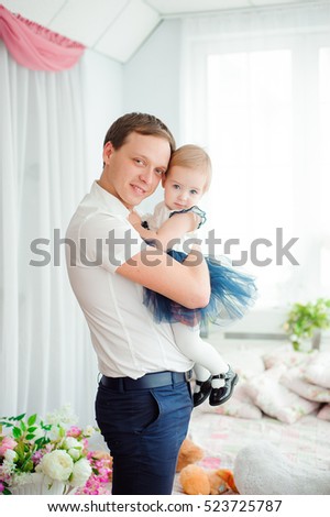 Dad hugging and kissing his little daughter