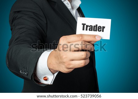 businessman holding trading card