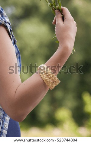 Bracelet made of straw on a female hand