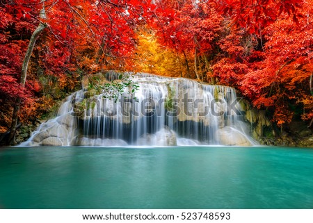 Beautiful colorful waterfall in autumn forest