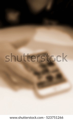 Blurred abstract background of Woman using a smart phone.