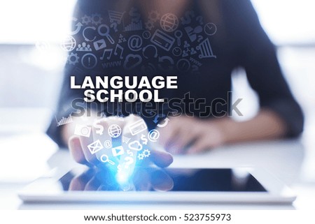 Woman is using tablet pc, pressing on virtual screen and selecting language school.