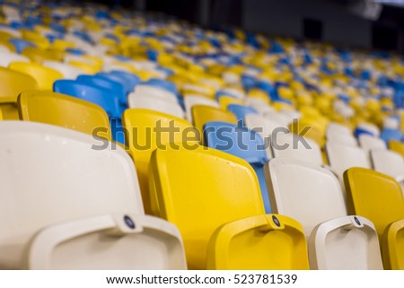 Rows of empty blue seats with the numbers