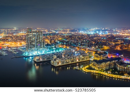 Aerial view of Federal Hill and the Inner Harbor at night, in Baltimore, Maryland.