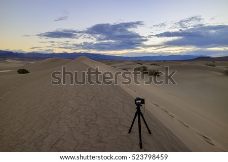 Camera taking photo of the beautiful Mesquite Flat Dunes at Stovepipe Wells, Death Valley National Park