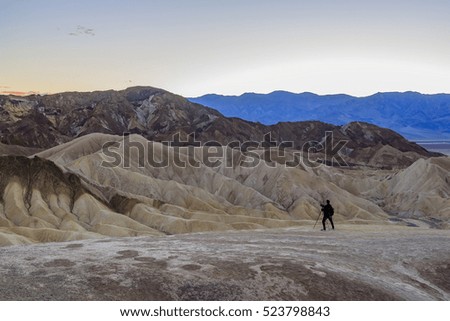 Photographer taking picture of beautiful view from Zabriskie Point, Death Valley National Park, California