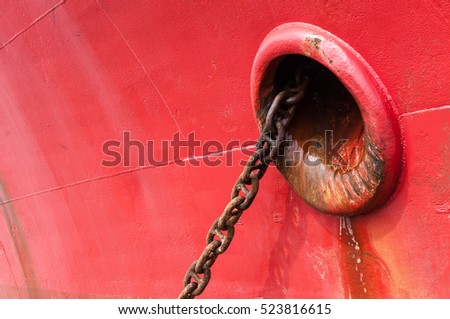 Red Ship Detail With big chain ,Ship staying at dock displays Royalty-Free Stock Photo #523816615