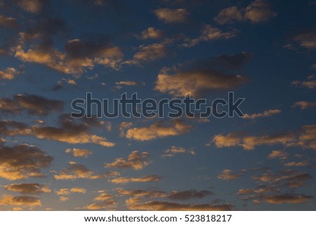 Sky with gold clouds - dramatic sunset, beautiful natural background. Setting sun illuminates the clouds. Sunsets of Fijii.