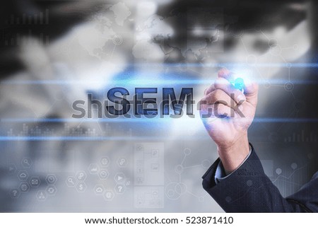Businessman is drawing on virtual screen. sem concept.