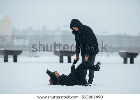young couple having fun in the park, in winter holidays