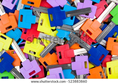 Multicolored key blanks, textured background image. 