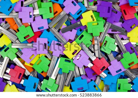 Multicolored key blanks, textured background image. 