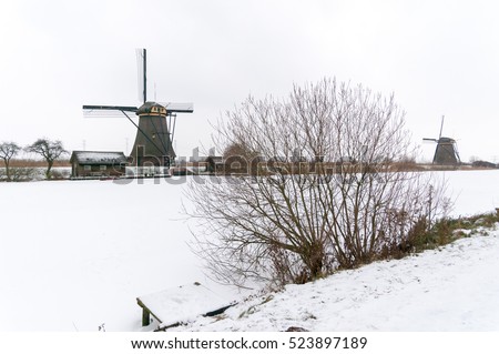  Windmill in a winter landscape snow and ice at Kinderdijk 