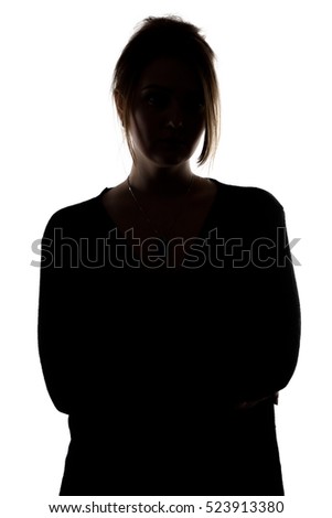 Silhouette of woman with arms crossed Royalty-Free Stock Photo #523913380