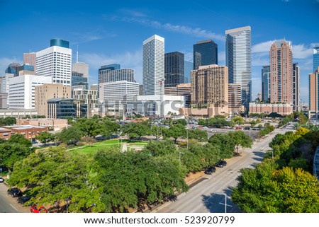 Aerial day view of Houston downtown skylines with green park trees and skyscrapers background in blue cloud sky. Houston is the most populous city in Texas and the fourth-most populous city in US.