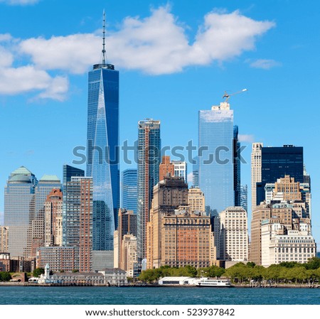The skyline of lower Manhattan seen from the New York Harbor on a beautiful summer day